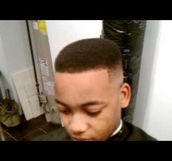 A black male with a higher fade haircut