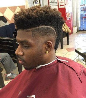 Mohawk fade haircut for black guys with shaved outlines