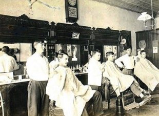 vintage barbershop males getting haircut early 1900s